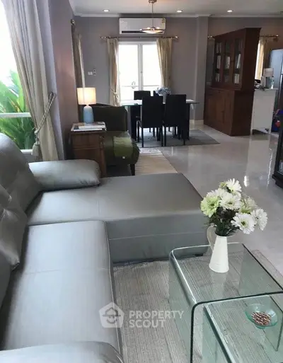 Spacious living room with modern furniture and elegant decor, perfect for family gatherings.