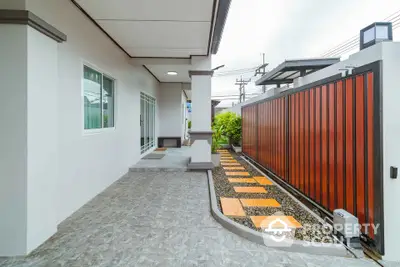 Modern home entrance with stylish pathway and sleek fence design