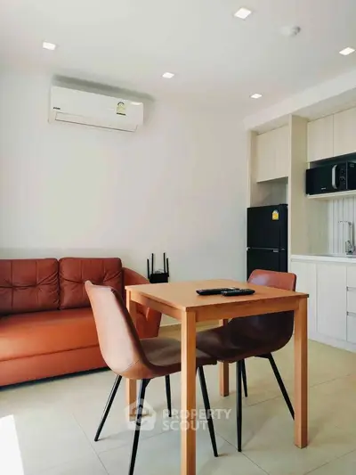 Modern living room with sleek furniture and integrated kitchen appliances