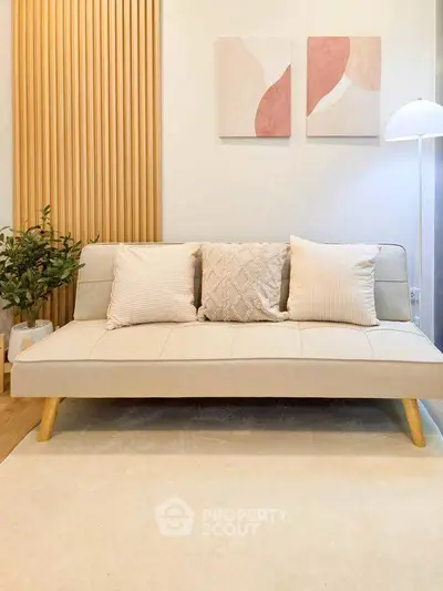 Stylish living room with modern beige sofa and elegant decor