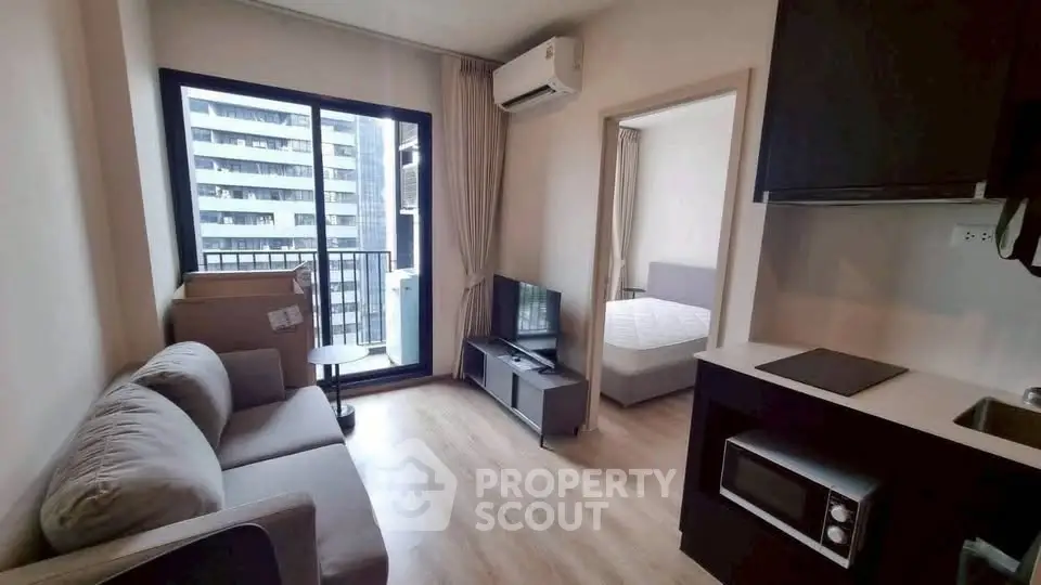 Modern apartment living room with balcony and kitchen view