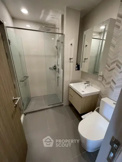 Modern bathroom with glass shower and sleek fixtures