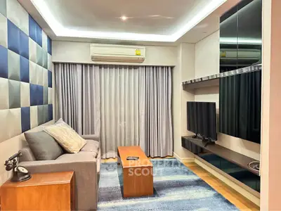 Modern living room with stylish decor, featuring a cozy sofa, sleek TV unit, and elegant lighting.