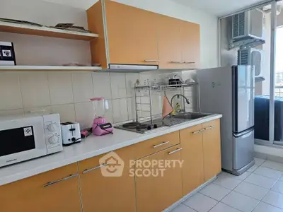 Modern kitchen with sleek cabinets, appliances, and ample counter space in a bright, airy setting.