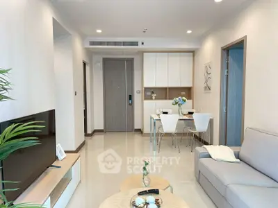 Modern living room with dining area, sleek furniture, and neutral tones.