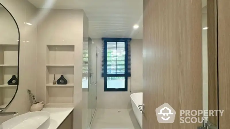 Modern bathroom with sleek design, featuring a bathtub and elegant fixtures.