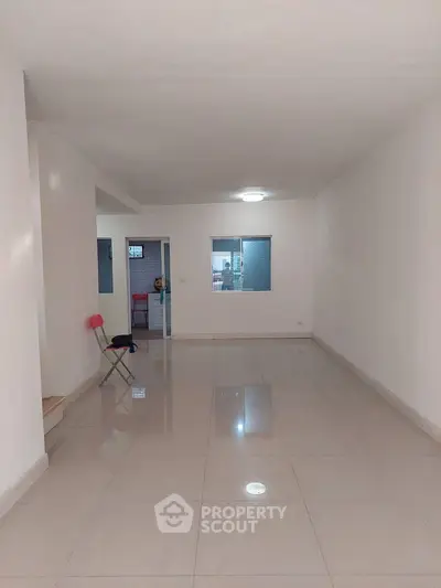 Spacious empty room with glossy tiled floor and minimalistic design