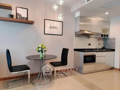 Modern kitchen with dining area, sleek cabinets, and stylish decor