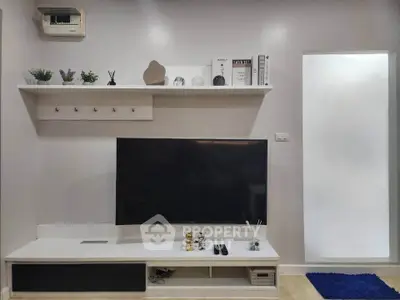 Modern living room with sleek TV setup and stylish shelving