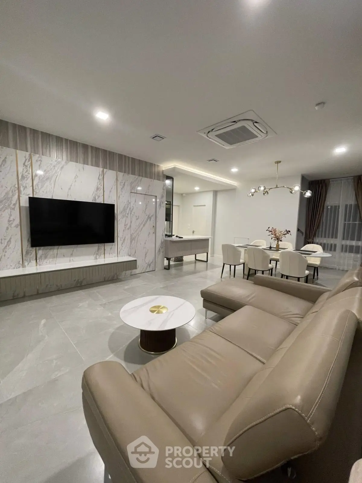 Luxurious modern living room with elegant marble accents and spacious open layout.