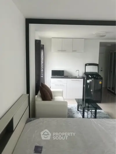 Modern studio apartment with compact kitchen and cozy living area