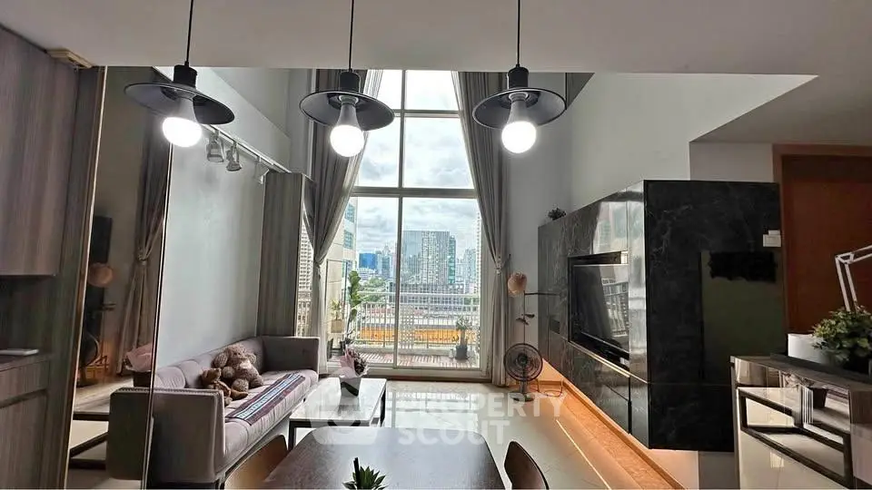 Luxurious modern living room with high ceilings and city view, featuring elegant lighting and stylish decor.