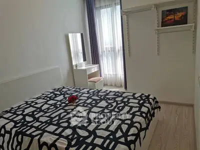 Cozy bedroom with modern decor and natural light, featuring a stylish bedspread and elegant vanity.