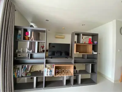 Modern living room with stylish shelving and TV setup