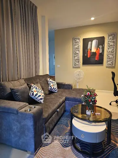 Stylish living room with modern gray sofa and artistic decor