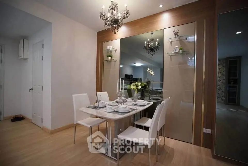 Elegant dining area with chandelier and modern decor in a stylish apartment