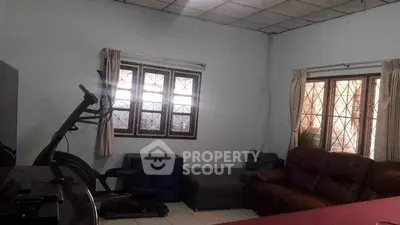 Spacious living room with exercise equipment and cozy seating area.