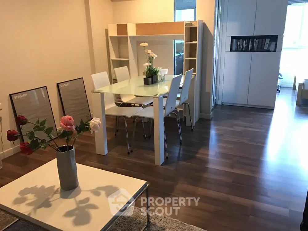 Modern dining area with glass table and stylish decor in a cozy apartment