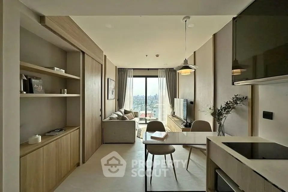Modern open-plan living room with city view, featuring sleek furniture and natural light.