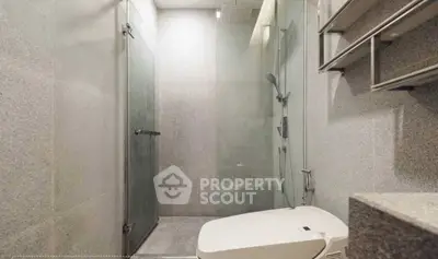 Modern bathroom with sleek shower and toilet design