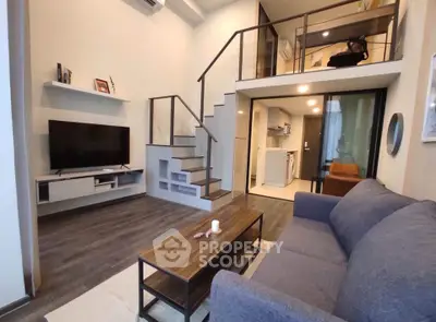 Modern loft-style living room with mezzanine and sleek furniture