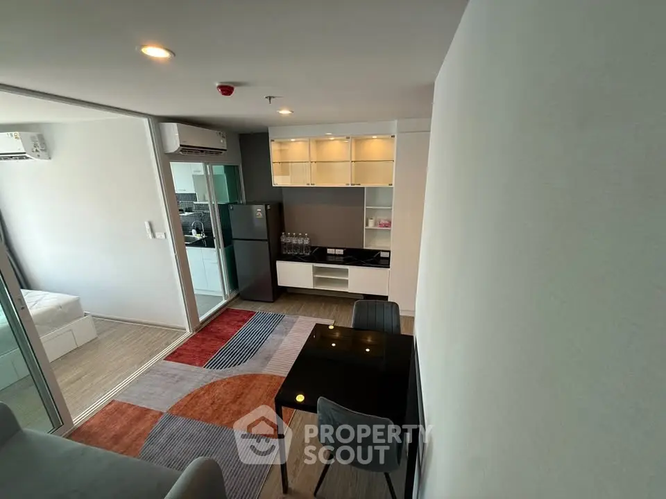 Modern apartment interior with open layout, featuring a stylish kitchen and cozy living area.