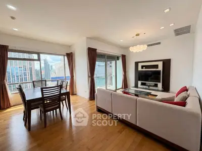 Spacious modern living room with city view, elegant dining area, and cozy seating in a high-rise apartment.