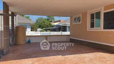 Spacious covered patio with stamped concrete flooring in suburban home