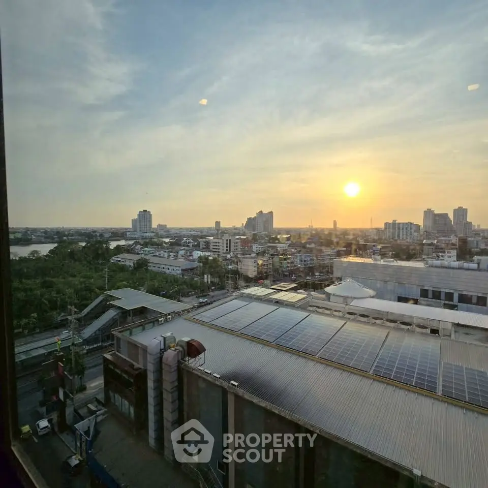 Stunning cityscape view with sunset over urban skyline and solar panels.