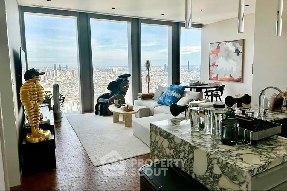 Luxurious living room with panoramic city views, modern decor, and marble kitchen island.