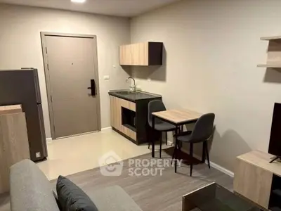 Modern compact living space with kitchenette and dining area, perfect for urban living.