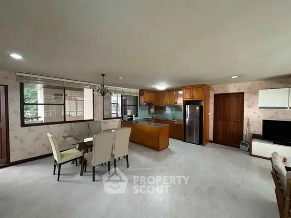Spacious open-plan kitchen and dining area with modern appliances and elegant decor.