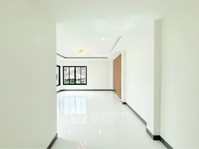 Spacious and bright living room with large windows and elegant flooring.