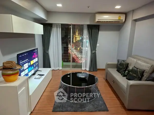 Modern living room with sleek furniture and city view from balcony.