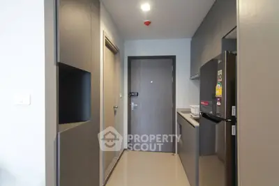 Modern kitchen with sleek cabinetry and stainless steel appliances in a compact layout.