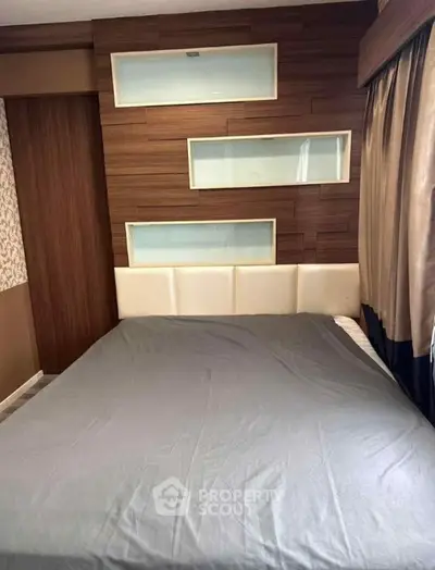 Modern bedroom with stylish wood paneling and cozy bed setup