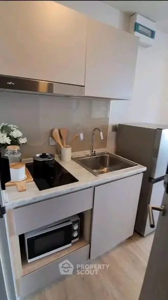 Modern compact kitchen with sleek appliances and stylish decor