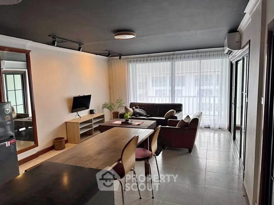 Spacious living room with modern decor and large windows for natural light.