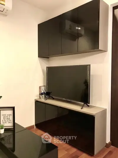 Modern living room with sleek TV cabinet and wall-mounted storage
