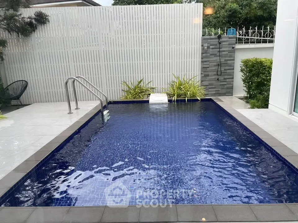 Luxurious private pool with modern design and lush greenery, perfect for relaxation and entertainment.