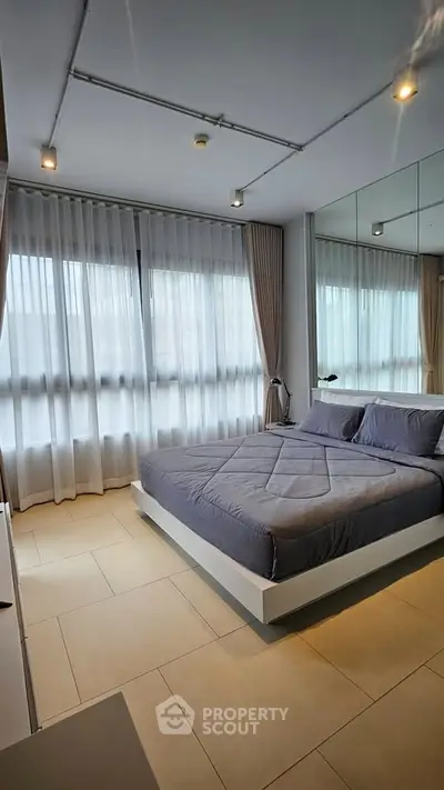 Modern bedroom with large windows and stylish decor