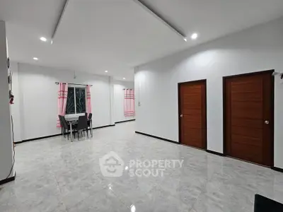 Spacious modern living room with elegant tile flooring and dining area.