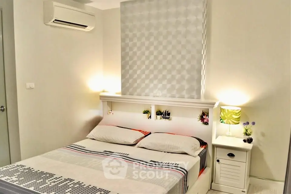 Cozy bedroom with modern decor and soft lighting, featuring a stylish air conditioning unit for comfort.