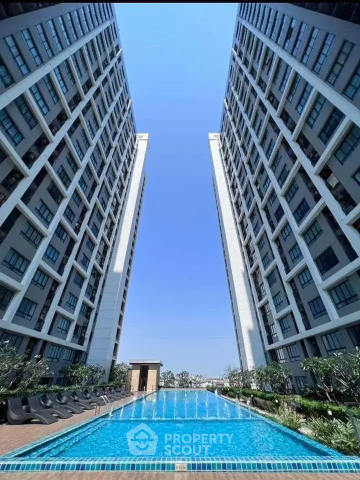 Stunning high-rise residential buildings with a luxurious swimming pool and lush landscaping.
