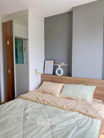 Cozy bedroom with modern decor and soft lighting, featuring a comfortable bed and stylish wall art.