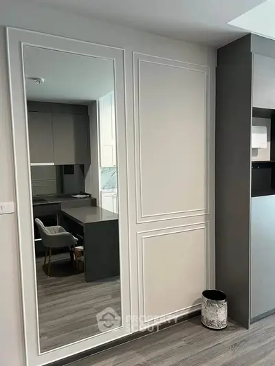 Modern study room with sleek design and large mirror, featuring elegant paneling and stylish flooring.