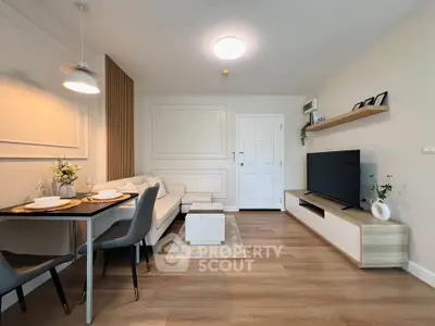 Modern living room with stylish decor, cozy seating, and sleek entertainment center.