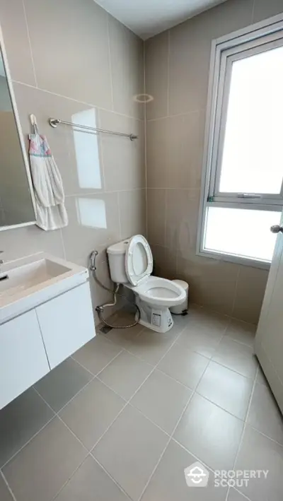 Modern bathroom with sleek fixtures and large window for natural light