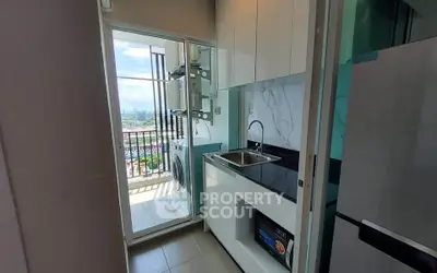 Modern compact kitchen with balcony view and washing machine