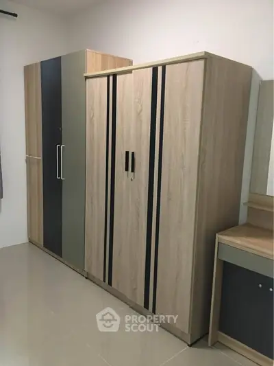 Spacious bedroom with modern wardrobes and sleek design.